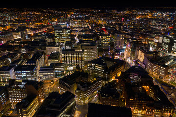 Night time aerial photo of the town centre of Leeds in West Yorkshire UK showing the bright lights...