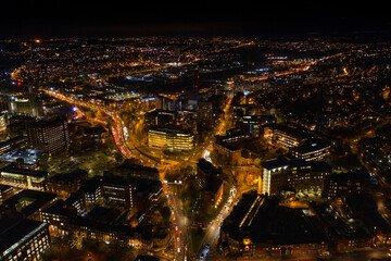 Naklejka premium Night time aerial photo of the town centre of Leeds in West Yorkshire UK showing the bright lights of the city and traffic at Christmas time