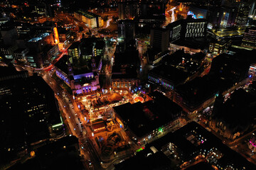 Night time aerial photo of the town centre of Leeds in West Yorkshire UK showing the bright lights...