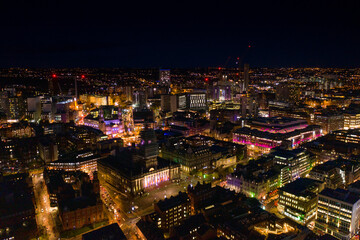 Fototapeta na wymiar Night time aerial photo of the town centre of Leeds in West Yorkshire UK showing the bright lights of the city and traffic at Christmas time