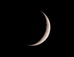 Crescent moon shines in midnight sky, a celestial event