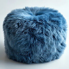 A blue fur covered round pillow. The pillow is blue and has a furry texture. It is sitting on a white background