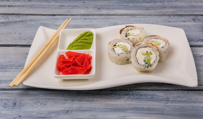 Fototapeta na wymiar Sushi presented on a beautiful plate, culinary concept, stock photo