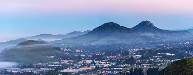 Panorama of valley, city, town, hills, mountains at sunset, sunrise