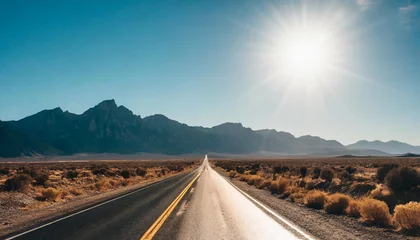 Foto op Plexiglas desolate desert road with mountains with sunflare western united stated © Adrian
