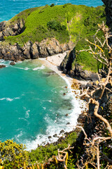 Hidden beach seen from cliff path on the north coast of Jersey, Channel Islands