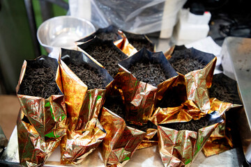Freshly picked tea is packaged in golden bags.