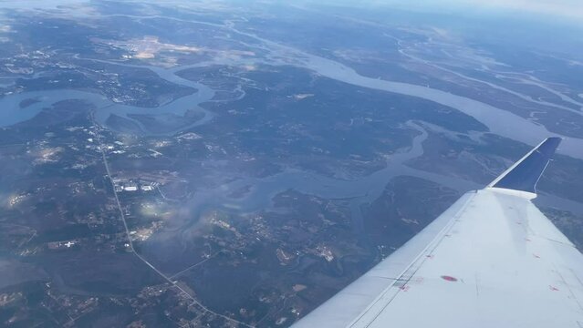 View flying over land in an airplane looking out the window.