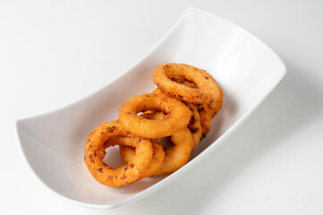 A plate of fried Onion Rings isolated on a white background 