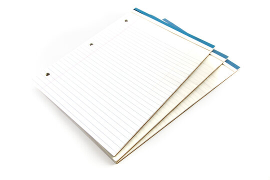 pads of white three hole punched note paper isolated on white