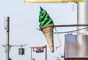 Green ice cream cone sign in front of a shop in Uji, Japan