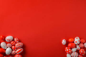 Easter backgrounds, scattered Easter red and white eggs on a bright red background. A place to copy. Flat position, top view