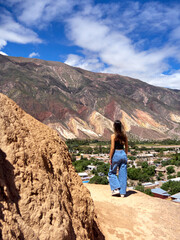 Woman walking to the hill of seven colors on a sunny day