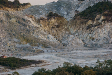Landscape of Solfatara at Campi Flegrei near Naples at evening with smoke and steam coming out the...