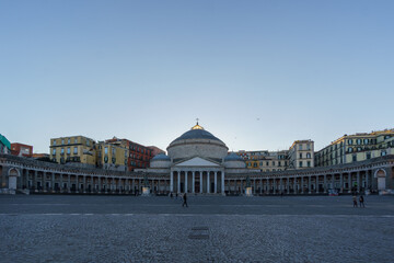 Cityscape of town square Piazza del Plebiscito with Basilica San Francesco di Paola under a clear...