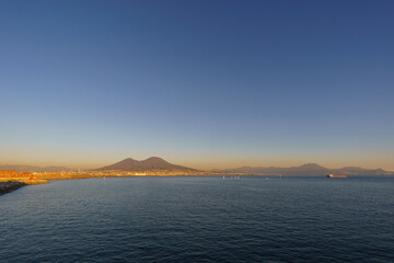Mount Vesuvius over the city of Naples during golden hour at sunset, Naples, Campania, Italy