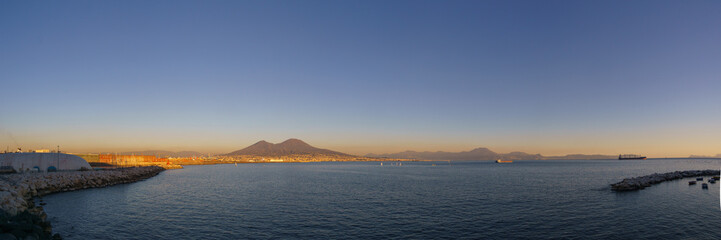 Panoramic view of mount Vesuvius over the city of Naples during golden hour at sunset, Naples, Campania, Italy