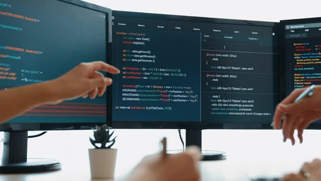 Slow motion back end software developer engineer for computer programming working together on debugging writing computing code, solving complex algorithms display on monitor in office. Burgeoning