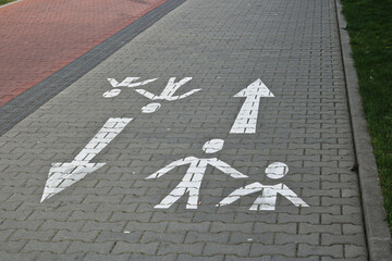 Pedestrian path in the city with a sign on the ground