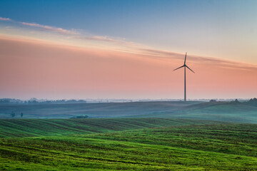 Beautiful sunrise at countryside with wind turbine
