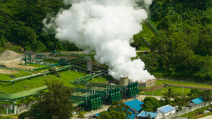 Aerial view of geothermal power production plant. Geothermal station with steam and pipes. Negros, Philippines.