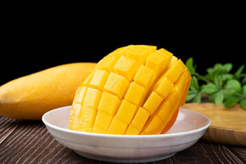 Mango. Close up of fresh ripe mango fruit on table.
