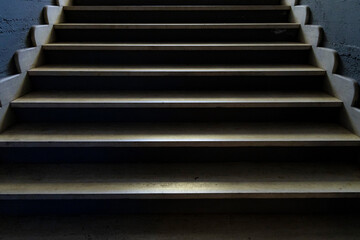 dark stairways with people photographed against the light climbing them
