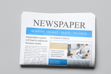 Modern newspaper on grey background