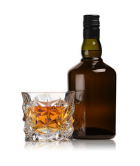 Glass and bottle of whiskey isolated on white