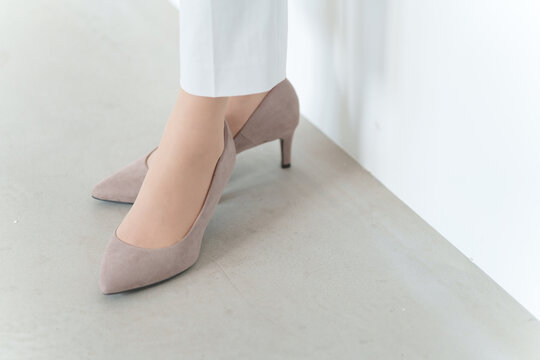 スエードのパンプスを履くビジネスウーマン