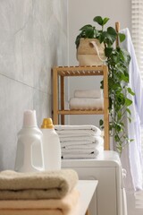 Soft towels, detergents and shelving unit indoors