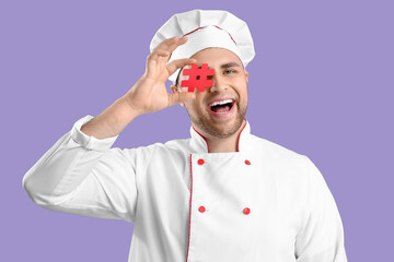 Male chef with hashtag on lilac background