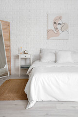 Fototapeta na wymiar Interior of modern bedroom with soft pillows on cozy bed