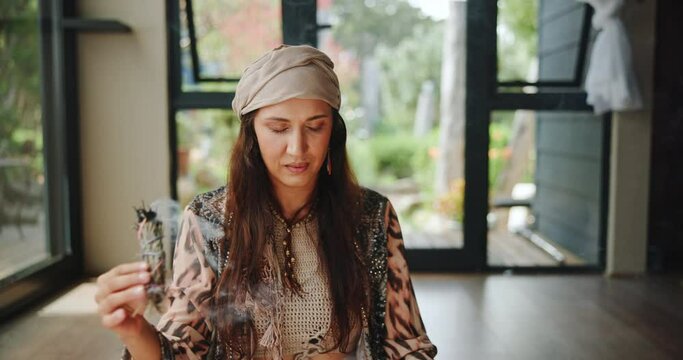 Shaman, ritual and woman with sage for healing, zen energy and balance with natural medicine. Herbs, aromatherapy and traditional, spiritual and holistic healer with incense, smoke and smudging