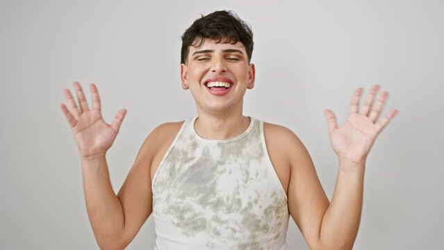 Excited young man in sleeveless t-shirt celebrating victory! handsome winner, standing isolated on white background, arms up and shouting yes for joy