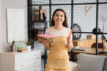 Female student with books and pencils at home