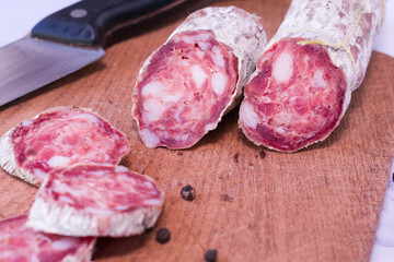 Sliced traditional argentine sausage on cutting board.