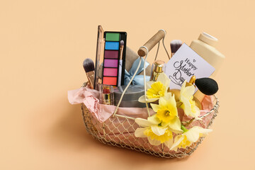 Gift basket with cosmetics and narcissus flowers for Mother's Day celebration on color background