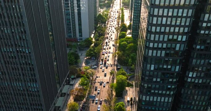 Aerial cityscape of Chengdu TianFu 3rd street busy traffic at sunset afternoon golden light 