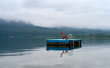 dock with a chair on the lake