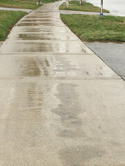 Wet asphalt sidewalk after rain