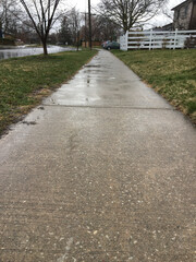 Wet asphalt sidewalk after rain