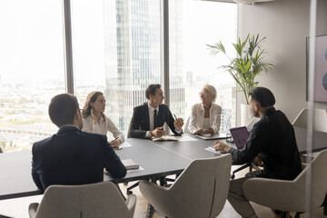 Businesspeople negotiating in conference room in modern city skyscraper office, five businesspeople...