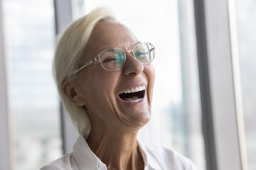 Close up portrait, face of attractive optimistic laughing middle-aged woman in eyeglasses, looking into distance, enjoy professional achievements, advertises eyewear store or dental clinic services - obrazy, fototapety, plakaty