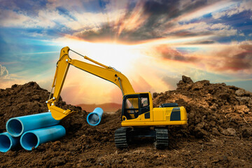 Crawler Excavator is digging soil in  construction site with  pipeline work on sunlight backgrounds.
