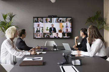 Foto op Plexiglas Group meeting using video call app. Multiethnic businesspeople profiles on screen, engaged in teleconference event by business, international communication of HR managers and applicants, career, tech © fizkes