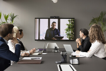 Arabic businessman speaker hold video conference for staff using application. Group of interested...