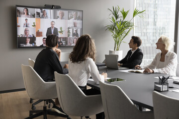 Worldwide communication by business using video conference application. Staff members engaged in...