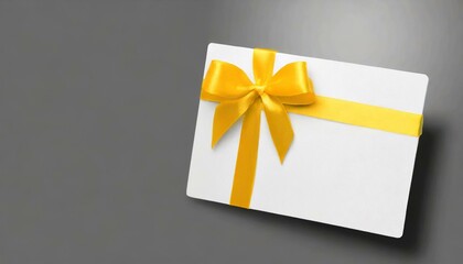 gift card with yellow ribbon, yellow gift card with a vibrant black ribbon bow right side, a minimalist grey background with subtle shadowing.