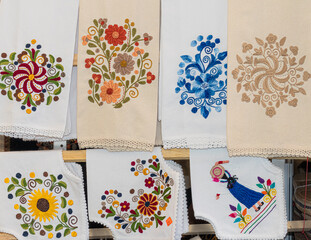 Embroidered doilies, napkins and table runners with flowers and ethnic design at open market in...